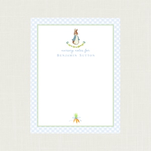 May include: A blue and white gingham border surrounds a white card with a Peter Rabbit illustration and the text "nursery notes for BENJAMIN SUTTON".