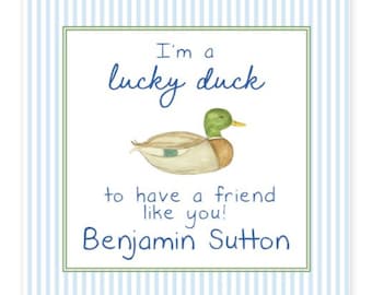 May include: Square card featuring a watercolour duck illustration and the text "I'm a lucky duck to have a friend like you!" in blue script. The card has a green border and a blue and white striped background. The name "Benjamin Sutton" is included.