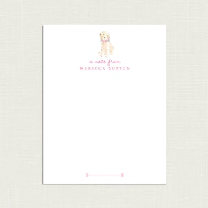 May include: A white card with a pink floral border and a watercolor illustration of a dog wearing a pink floral collar. The text "a note from REBECCA SUTTON" is printed in pink below the dog.