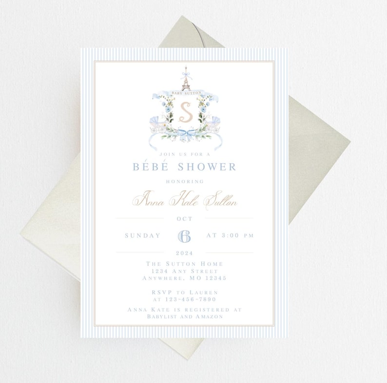 Pode incluir: Um convite para um ch&aacute; de beb&ecirc; em listras azuis e brancas com uma ilustra&ccedil;&atilde;o em aquarela de um monograma com tema parisiense. O convite diz "Join us for a Bebe Shower honoring Anna Kale Sutton, Sunday, October 6th at 3:00 PM. The Sutton Home, 1204 Any Street, Anywhere, MO 12345. RSVP to Lauren at 123-456-7890. Anna Kate is registered at Babylist and Amazon."
