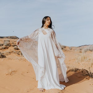 a bride in a white dress in the desert