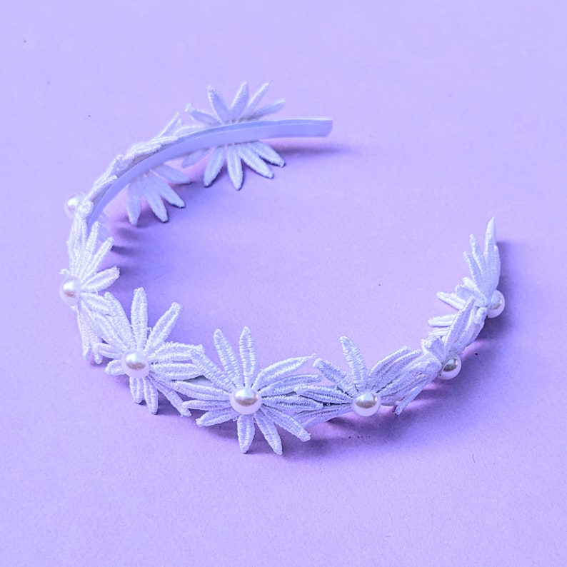 a white headband with flowers and pearls