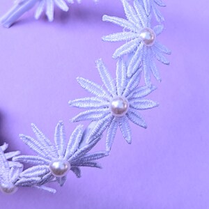 a white headband with flowers and pearls