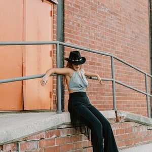 a woman sitting on the steps of a brick building