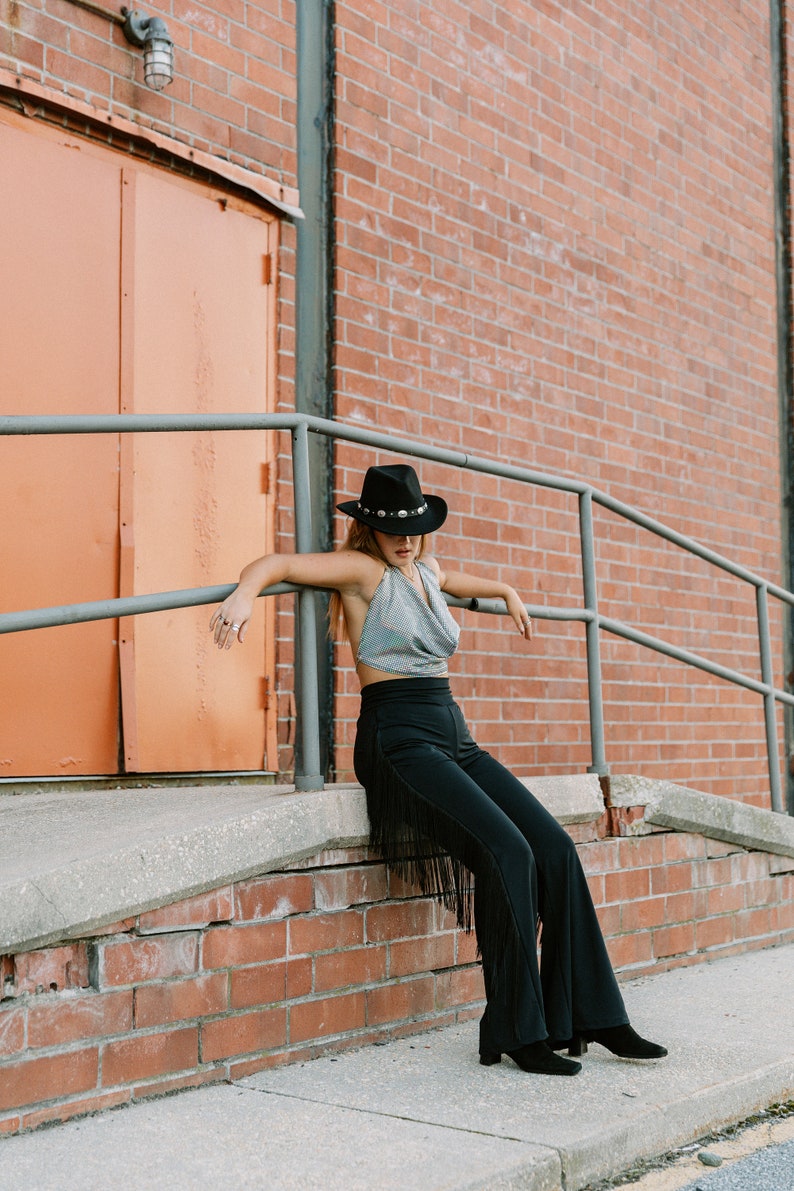 a woman sitting on the steps of a brick building