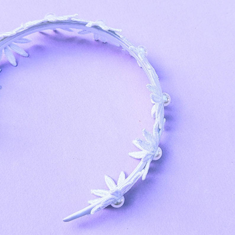 a white headband with flowers and pearls