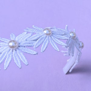 a white headband with flowers and pearls