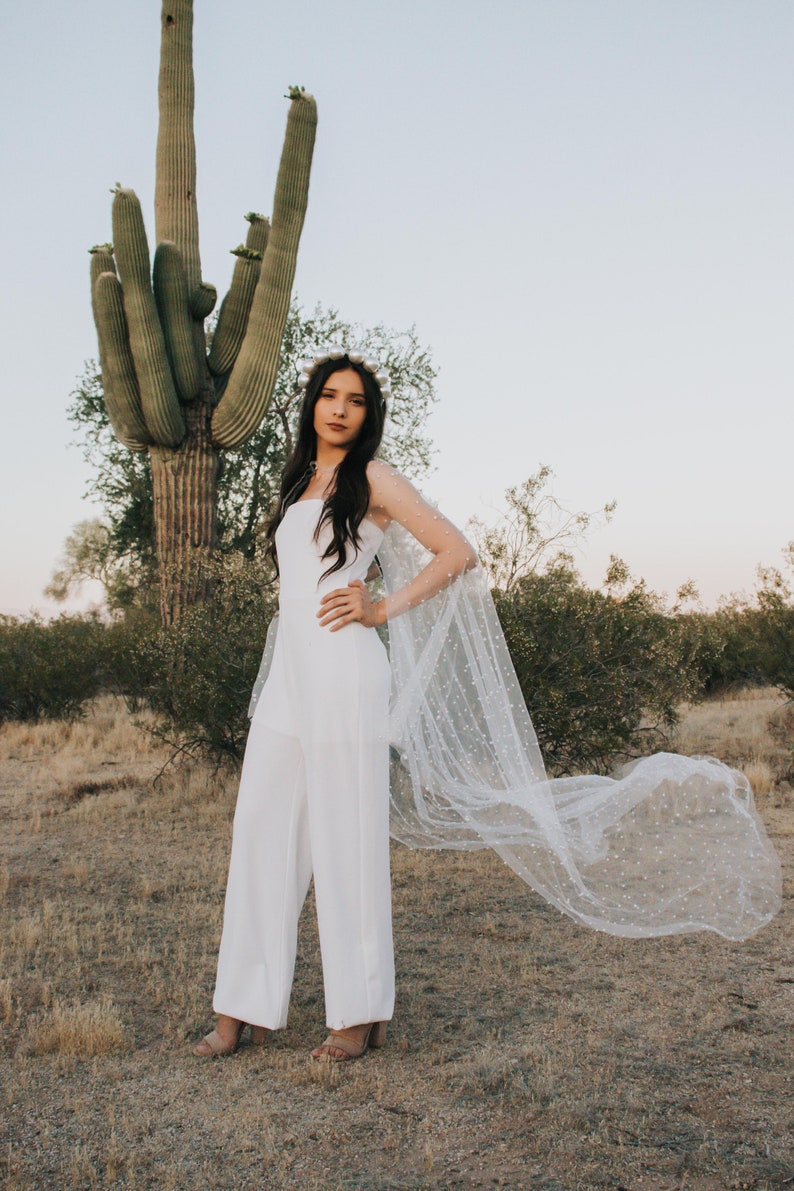 a bride standing in front of a cactus