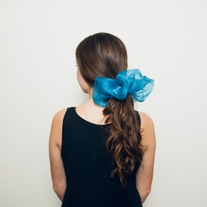 a woman with a blue bow in her hair