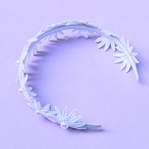 a white headband with flowers and pearls