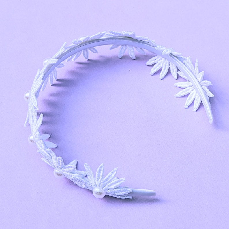 a white headband with flowers and pearls