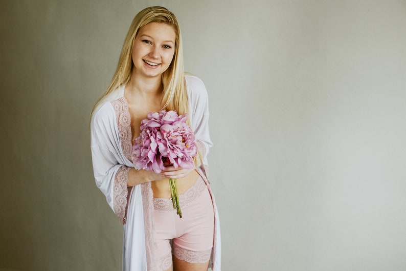 a bride wearing a lace robe and shorts