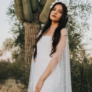 a bride standing in front of a large cactus