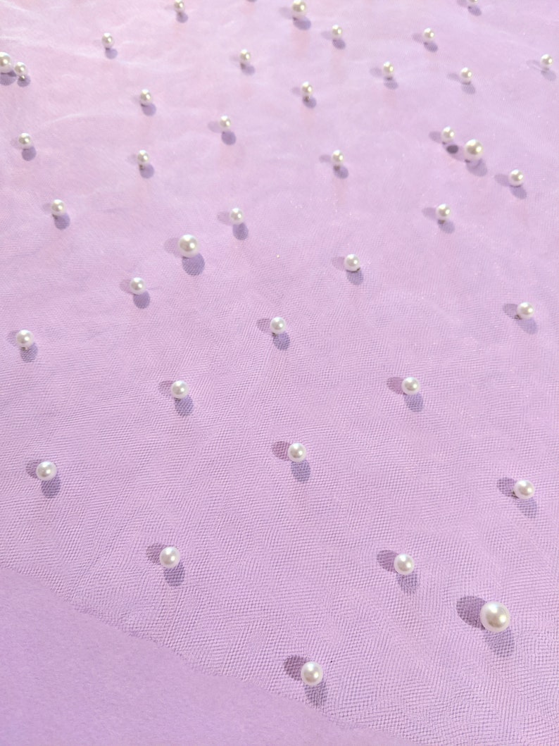 a bunch of pearls on a mesh surface