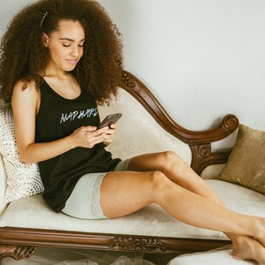 a girl lounging on a couch wearing biker shorts