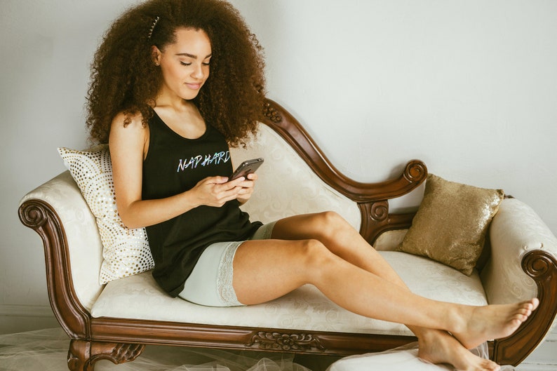 a girl lounging on a couch wearing biker shorts