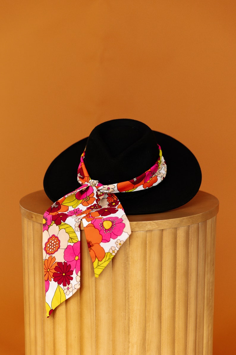 a hat and a scarf are on top of a wooden box