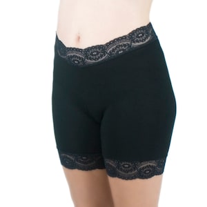 a woman in black shorts with a black lace trim