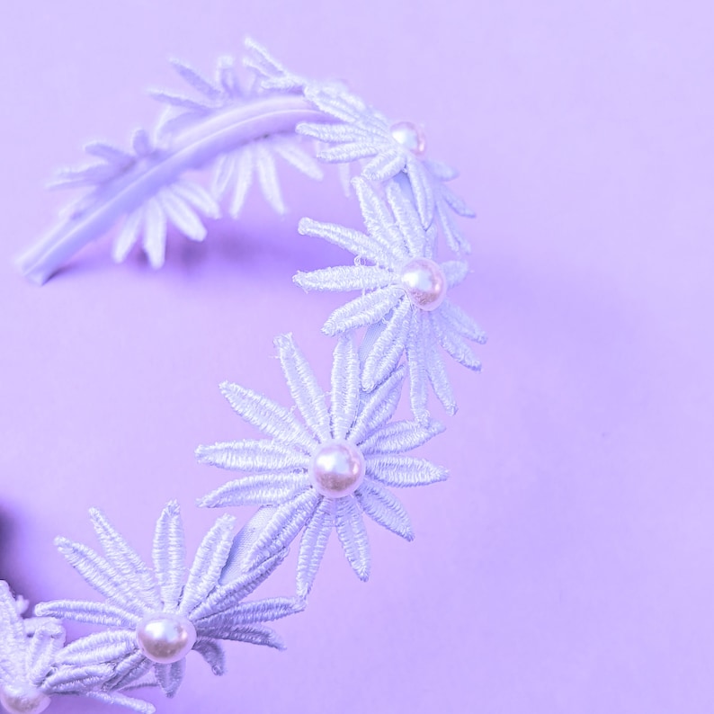 a white headband with flowers and pearls