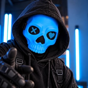 May include: A bright blue skull mask featuring a black mesh eye area with an 'X' symbol on the left and a heart shape on the right. The mask is worn with a black hooded sweatshirt and black tactical gloves, creating a high-contrast appearance.
