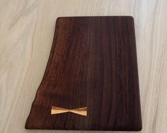 Black Walnut Live Edge with Olive wood bowtie inlay cutting board