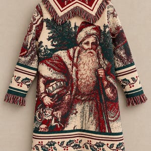 May include: A long-sleeved coat made of woven tapestry fabric featuring a detailed image of Santa Claus, evergreen trees, and holly berry patterns. The garment includes a wide collar, fringe trim on the hem and cuffs, and a cream background.