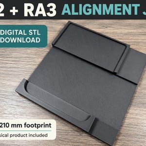 May include: A black F2 + RA3 alignment jig with a 210 x 210 mm footprint. The square tool features a raised rectangular border and a curved channel for positioning. Text on the image reads F2 + RA3 ALIGNMENT JIG and DIGITAL STL DOWNLOAD.