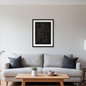 May include: A framed wall art print featuring a black background with a complex, repeating geometric pattern of white lines and squares. The artwork is enclosed in a thin black frame with a white mat border, displayed centred on a plain wall.