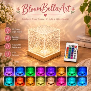 May include: A square, textured acrylic lamp on a light wood base, accompanied by a remote control. The lamp features 16 color modes, adjustable brightness, and is USB powered. Text includes BloomBellaArt, Brighten Your Space, Add a Little Magic.