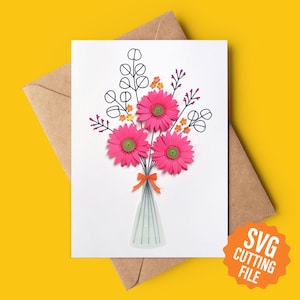May include: A white card featuring a pink paper flower bouquet in a vase. The flowers have green centres and orange accents. The card has a black outline of the flowers and leaves. The text "SVG CUTTING FILE" is on an orange circle.