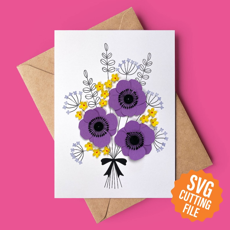 May include: A white card featuring a bouquet of purple and yellow paper flowers. The flowers are arranged in a vase and have a black ribbon tied around the stems. The card has the text "SVG Cutting File" in a yellow circle.