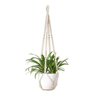May include: A beige macrame plant hanger holding a white ceramic pot with a green spider plant. The text at the top reads 3 Macrame Patterns - PDF Easy Beginner Tutorial | Bohoknots. The hanger features knotted cord and light wooden beads.