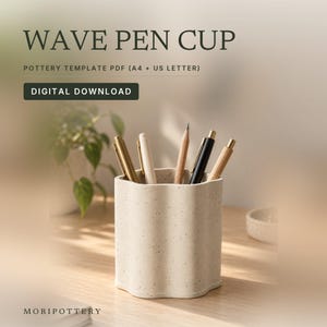 May include: A beige speckled ceramic pen cup with a wavy, scalloped edge design. The text reads WAVE PEN CUP, POTTERY TEMPLATE PDF (A4 + US LETTER), DIGITAL DOWNLOAD, and MORIPOTTERY. Several pens and a pencil are stored inside the cup.