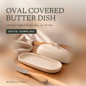May include: An oval covered butter dish pottery template PDF digital download. The image shows a beige ceramic oval butter dish with a lid and a handle, accompanied by a butter knife with a wooden handle and a textured cloth.