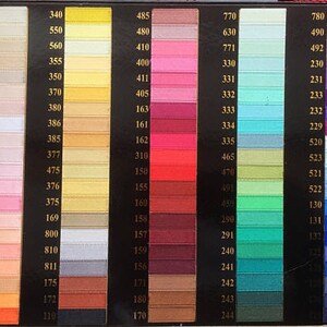May include: A color chart with rows of different colored ribbon samples. The chart is labeled with numbers from 110 to 811.
