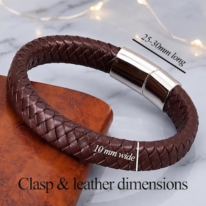May include: A dark brown braided leather bracelet featuring a polished silver-tone metal magnetic clasp. The bracelet is 10 mm wide, and the clasp measures 25-30 mm long. The text "Clasp & leather dimensions" is visible at the bottom.