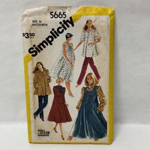 May include: A Simplicity 5665 maternity sewing pattern envelope, size 16, featuring illustrations of various garments including a floral print dress, a patterned tunic with pants, a solid dress with a bow, and a solid jumper over a floral blouse.