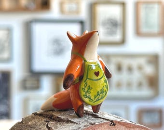 Tiny ceramic fox figurine in an apron, inspired by Hansel and Gretel
