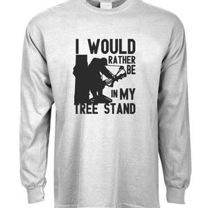 May include: A gray long-sleeve t-shirt with the text "I would rather be in my tree stand" and a silhouette of a person in a tree stand holding a bow and arrow.