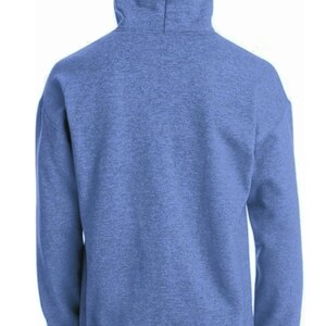 May include: A light blue hooded sweatshirt, seen from the rear. The hoodie has a drawstring hood and long sleeves. The fabric has a textured look. The person is wearing dark blue jeans.