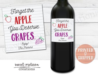 May include: A printable wine bottle label with a white background and black lines. The text reads "Forget the APPLE You Deserve GRAPES. Enjoy! The Parkers". There is a red apple and purple grapes on the label.