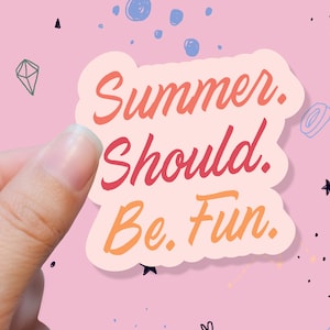 May include: A sticker with the text "Summer. Should. Be. Fun." in orange and red lettering. The sticker is held by a hand against a pink background with doodles of stars and shapes.