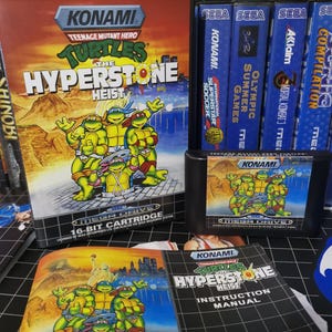 May include: A Teenage Mutant Hero Turtles The Hyperstone Heist video game for the Sega Mega Drive, including the black plastic game case with cover art, the game cartridge with a matching label, and the printed instruction manual booklet.