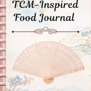 May include: A journal titled TCM-Inspired Food Journal featuring a light-coloured cover with a watercolour landscape illustration of mountains and trees. A light wood folding fan with intricate cut-out patterns is centred on the front cover.