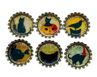 May include: Six round, gold-colored bottle caps with black cats and Halloween-themed designs. The designs include a black cat with a broom, a black cat in a pumpkin, a black cat with a bat, a black cat with a witch's hat, a black cat with a crescent moon, and a black bird on a branch.