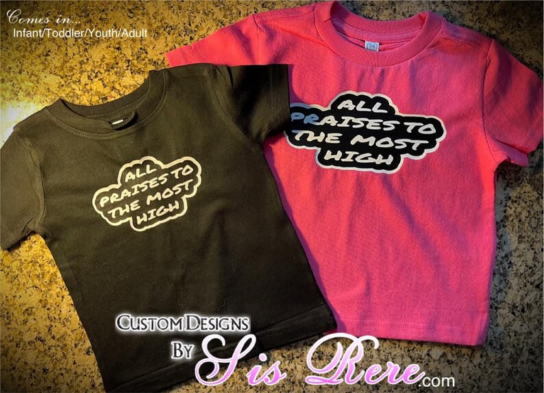May include: Two short-sleeved t-shirts, one black and one pink, each displaying the text "ALL PRAISES TO THE MOST HIGH" in a white and black design. The shirts are for infants, toddlers, youth, and adults.