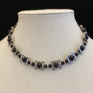 Hand crafted black faceted glass beads with silver metal bead  frames