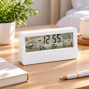 May include: A white rectangular digital clock with a clear LCD screen displaying the time 12:55 AM, the day WED, the date 1/1, a temperature of 35°C, a humidity level of 54%, and a weather icon showing a sun behind clouds.
