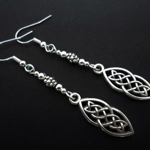 A pair of tibetan silver celtic knot themed long dangly earrings. new.