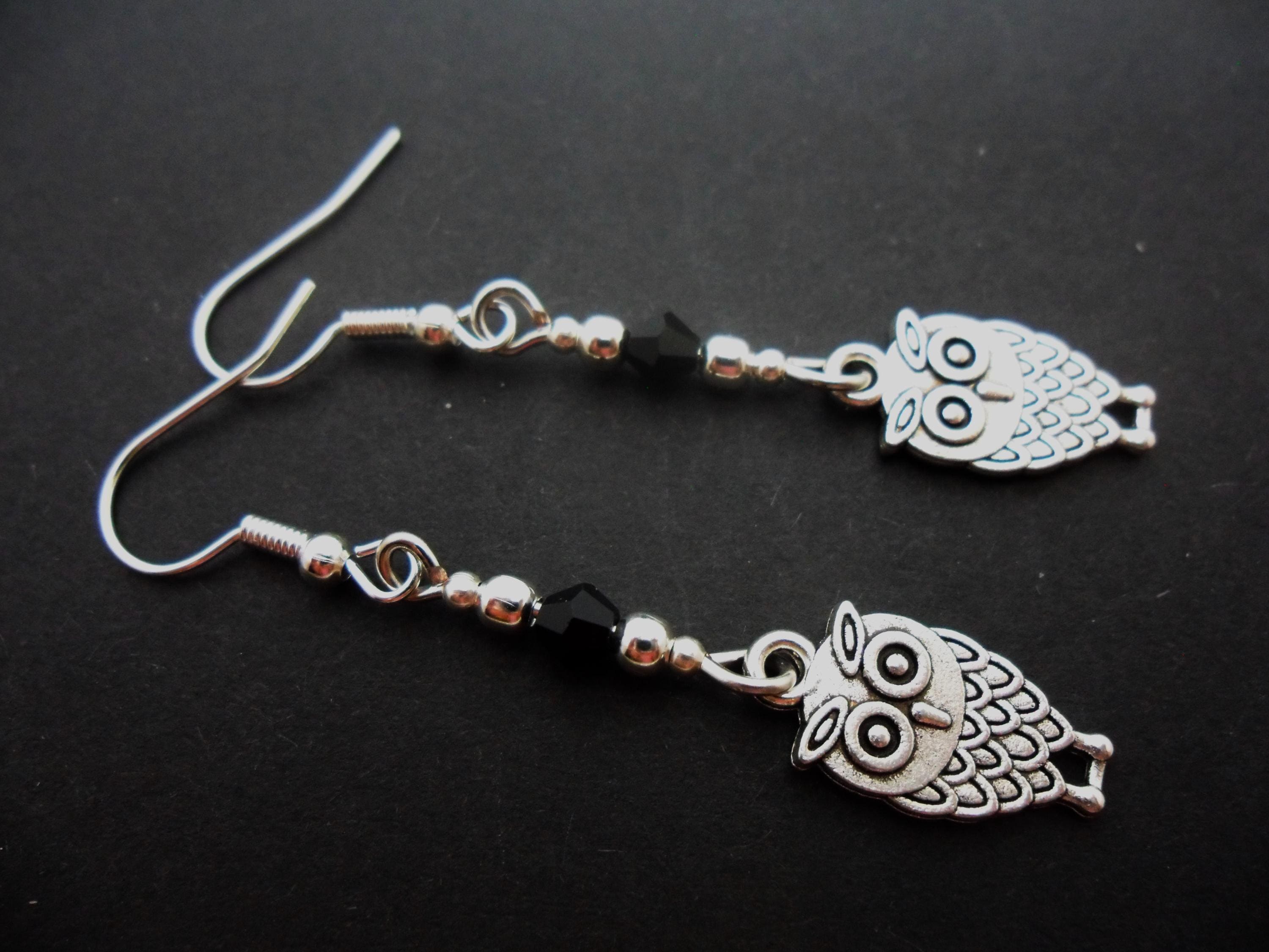 A pair of tibetan silver and black bead owl themed dangly earrings. New.